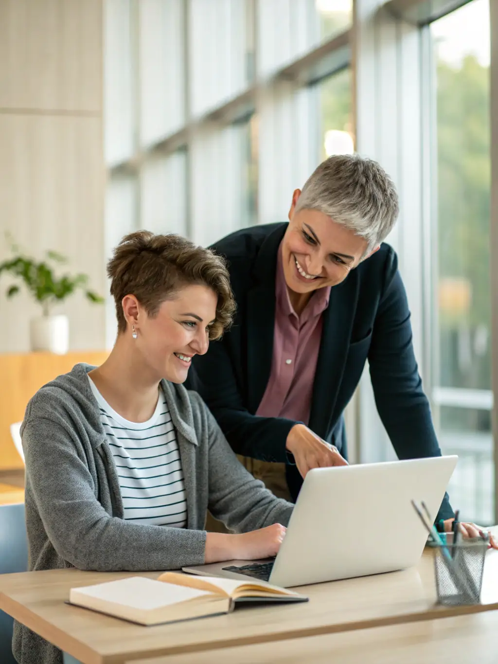 A photograph of a student meeting with an academic advisor in a modern office setting at Platform Sixth-Form College, discussing course options and academic goals.